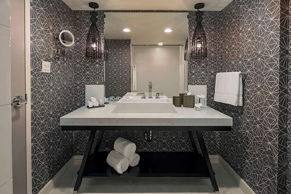 Rejuvenate with a sleek vanity and crisp, fresh towels.