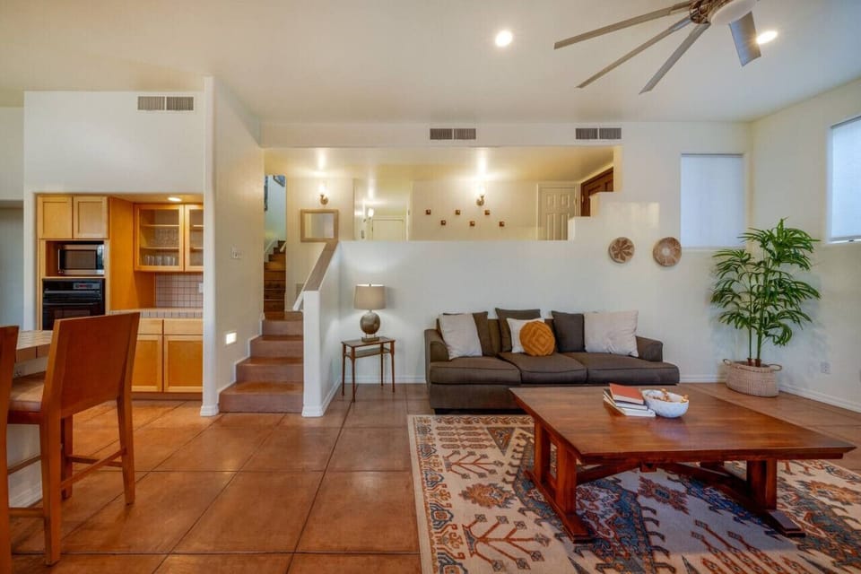 Living room with cozy seating leading to the kitchen on the left