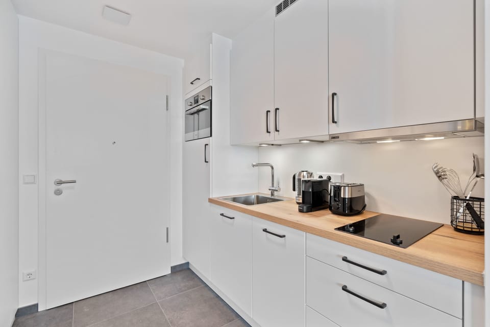 Bright and clean kitchen with a sleek design, perfect for preparing meals during your stay.