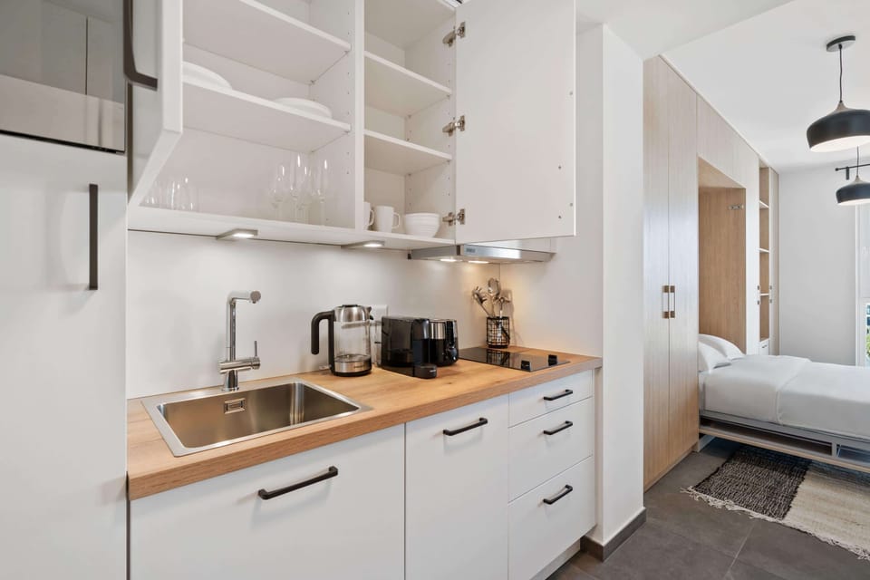 Fully equipped kitchen with open shelving, modern appliances, and ample counter space for all your cooking needs.