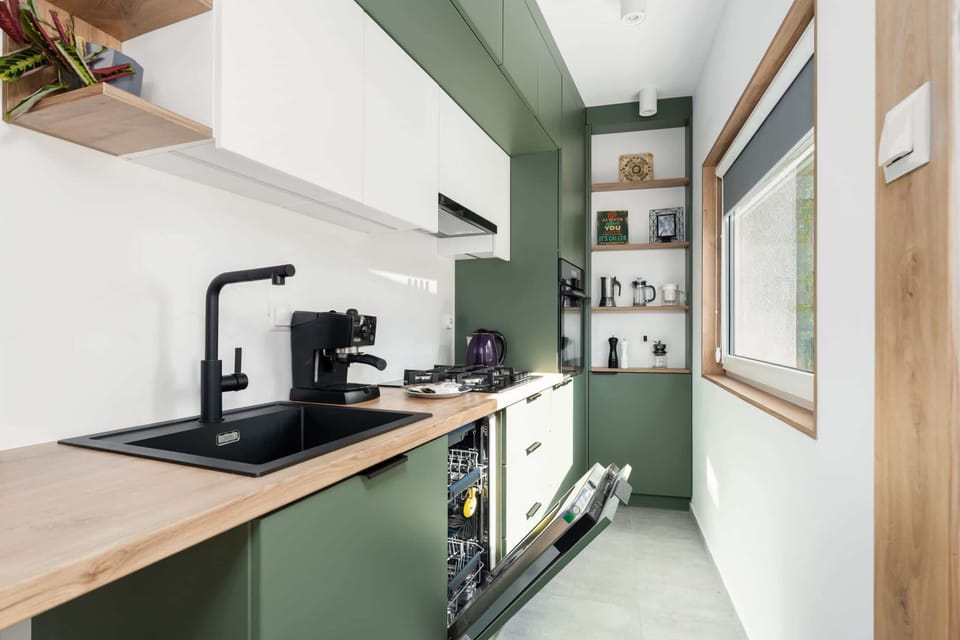 Fully equipped kitchen with a wooden countertop, coffee maker, and functional design.

