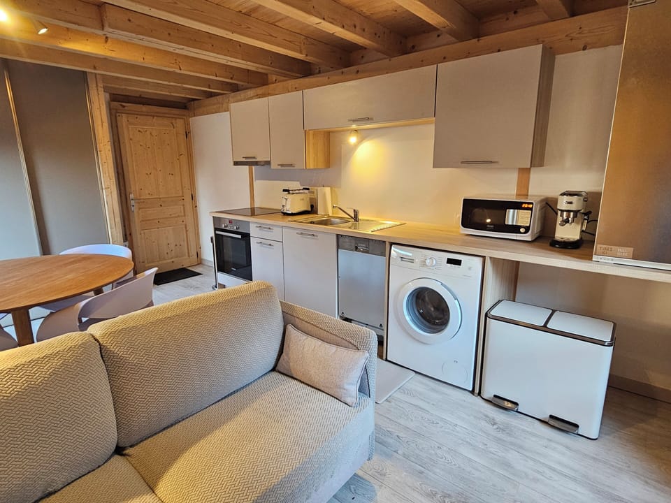 The compact kitchen includes a dishwasher, washing machine, and more.