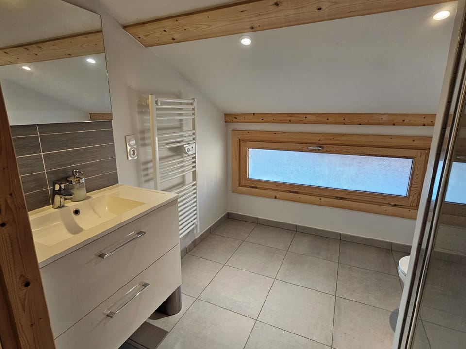 A spacious and updated full bathroom.