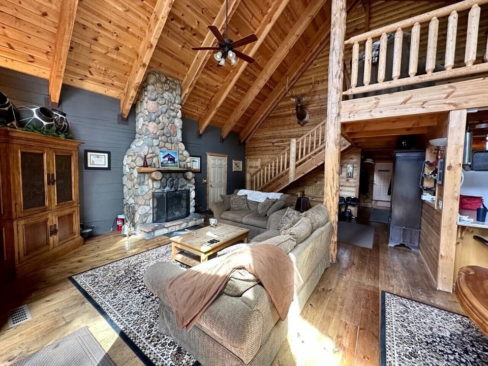 Living Room with Flat Screen and Wood-Burning Stone Fireplace 