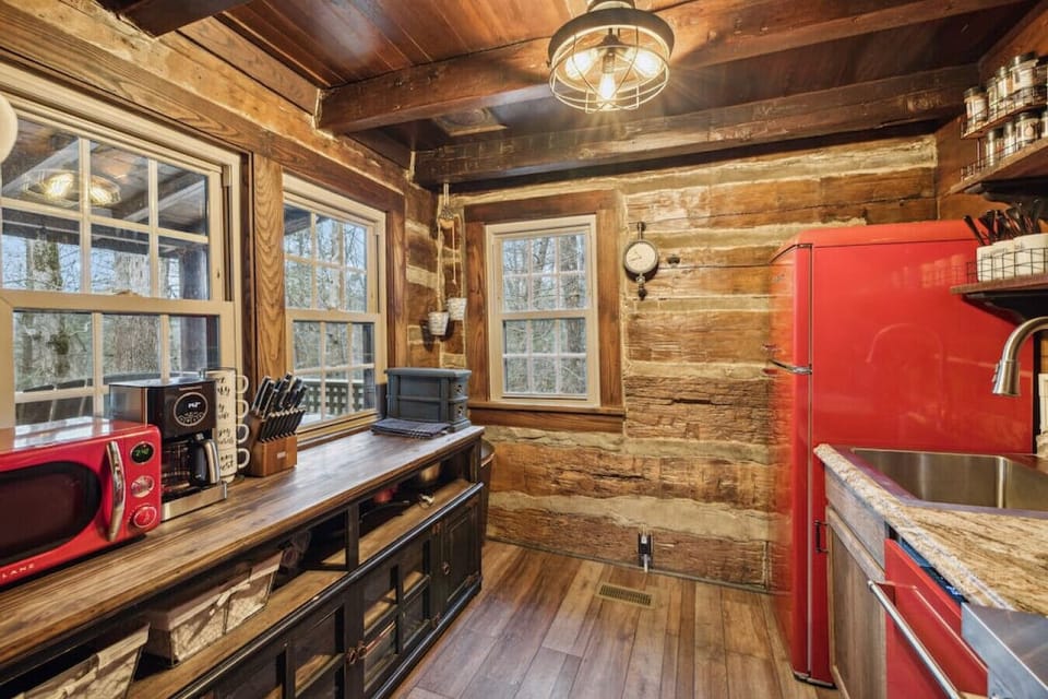 Step into this restored kitchen with new cherry red nostalgic appliances! Well-stocked for your stay.