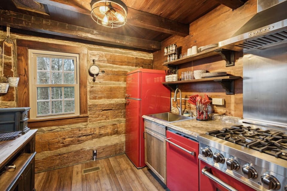 Step into this restored kitchen with new cherry red nostalgic appliances! Well-stocked for your stay.