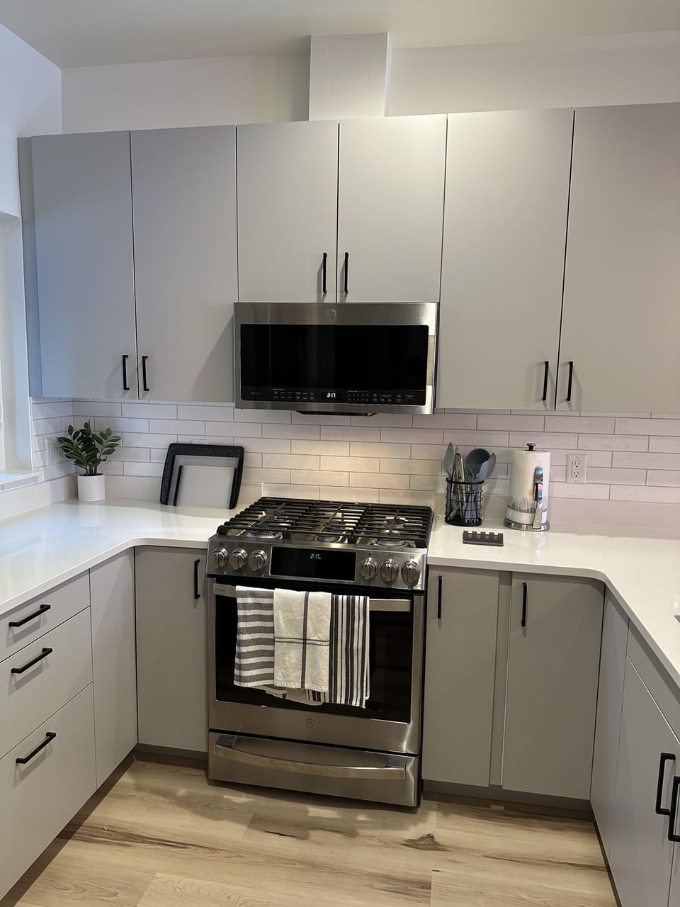 Kitchen - oven, gas stove, microwave, and dishwasher.