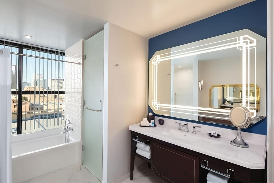 Refresh in a bright bath with illuminated mirror and deep tub.