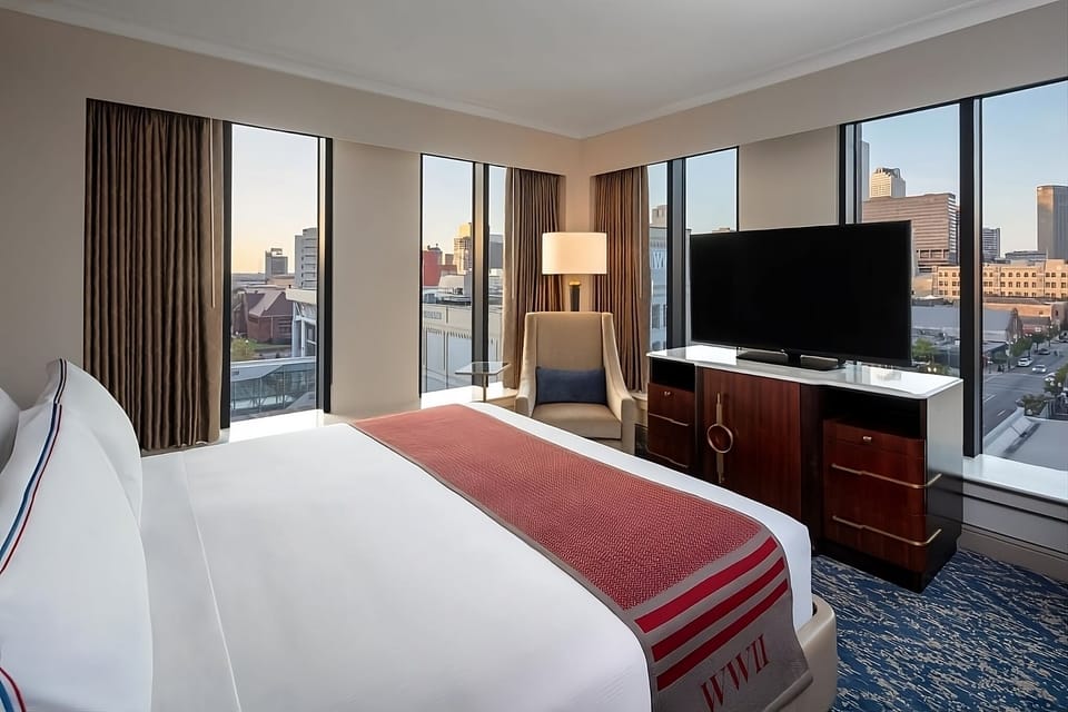 Wake up to sweeping skyline views from a plush bed.