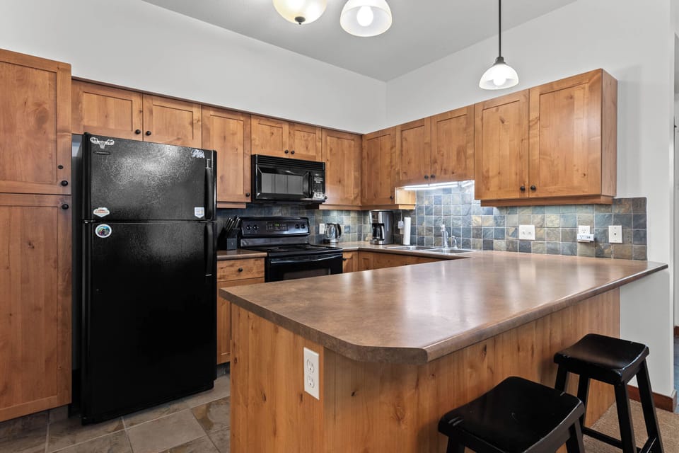 spacious kitchen stocked with small appliances and all your cooking needs. 