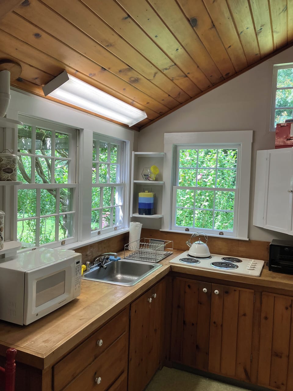 Kitchen with range, fridge, toaster oven, coffee maker, and microwave
