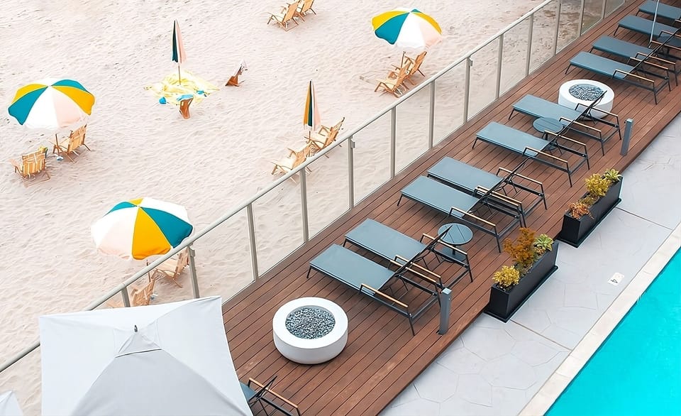 Unwind poolside on sleek loungers steps from the sand