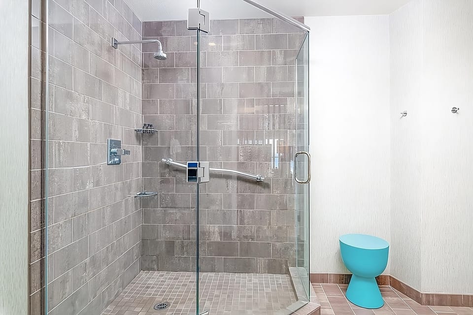 Rinse off after the beach in a spacious glass shower.