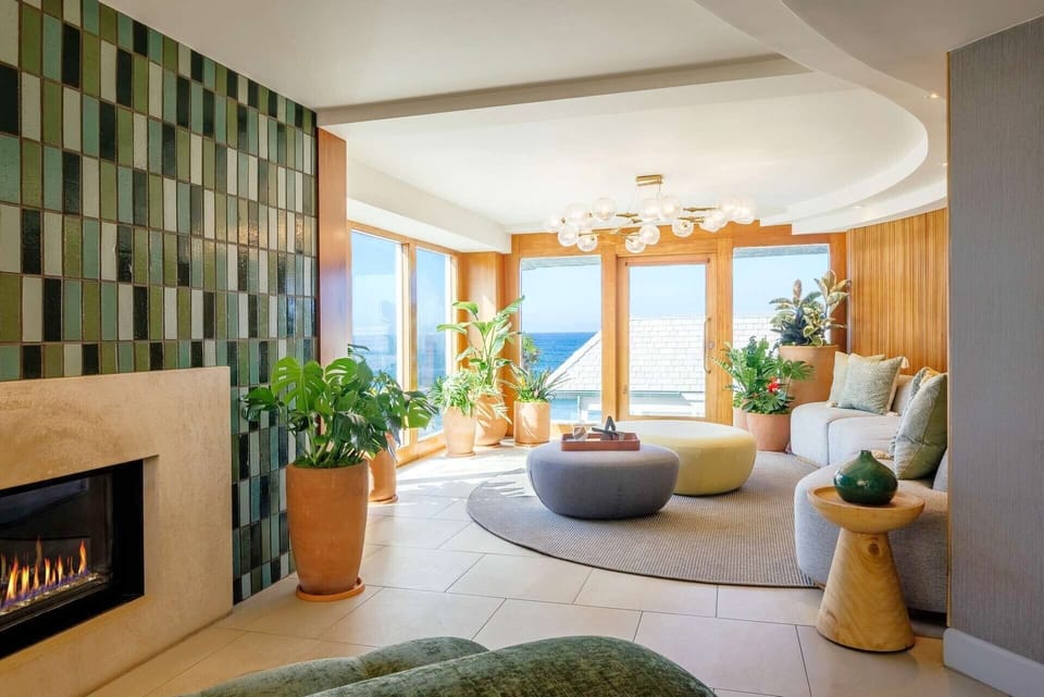 Relax by the fireplace with sunlit ocean views all day