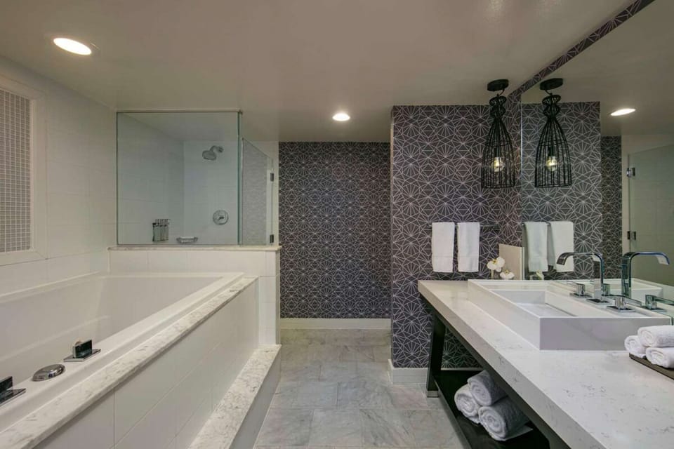 Refresh in a spa-like bath with soaking tub and glass shower.