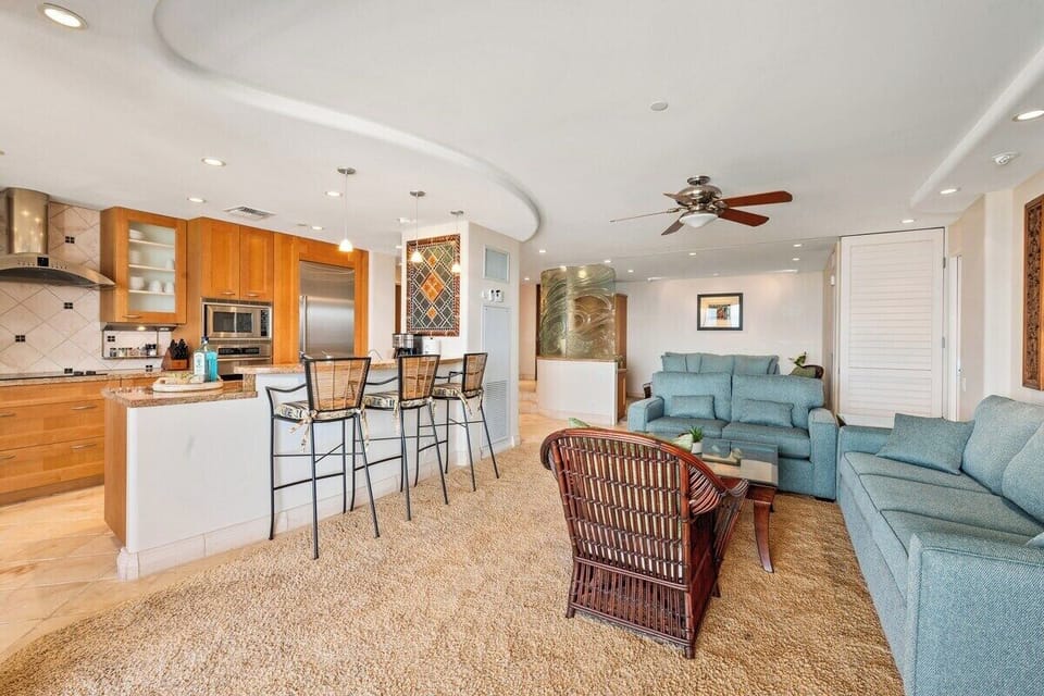 Gather in this spacious open-concept living area with cozy seating and ocean breeze