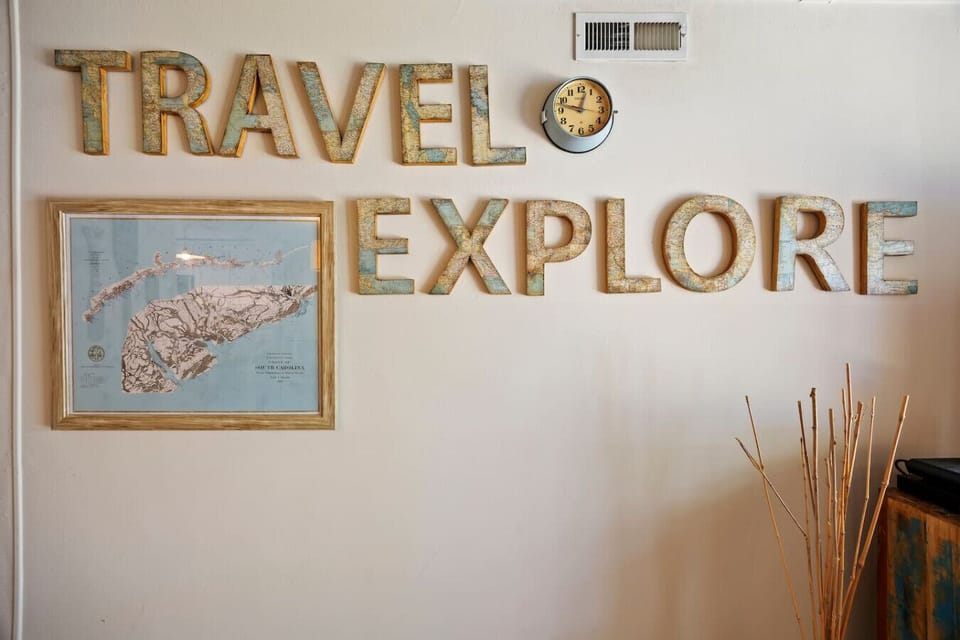 “Travel & Explore” wall with coastal accents. Adds character and style.