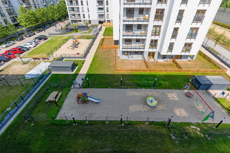 A well-maintained outdoor area with a playground and green spaces, perfect for families.
