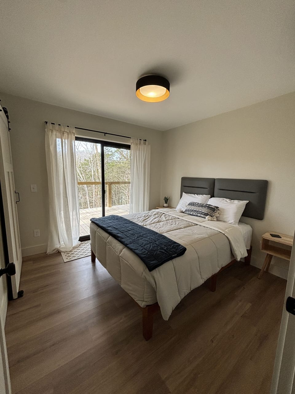 First floor Queen bedroom with covered porch access.