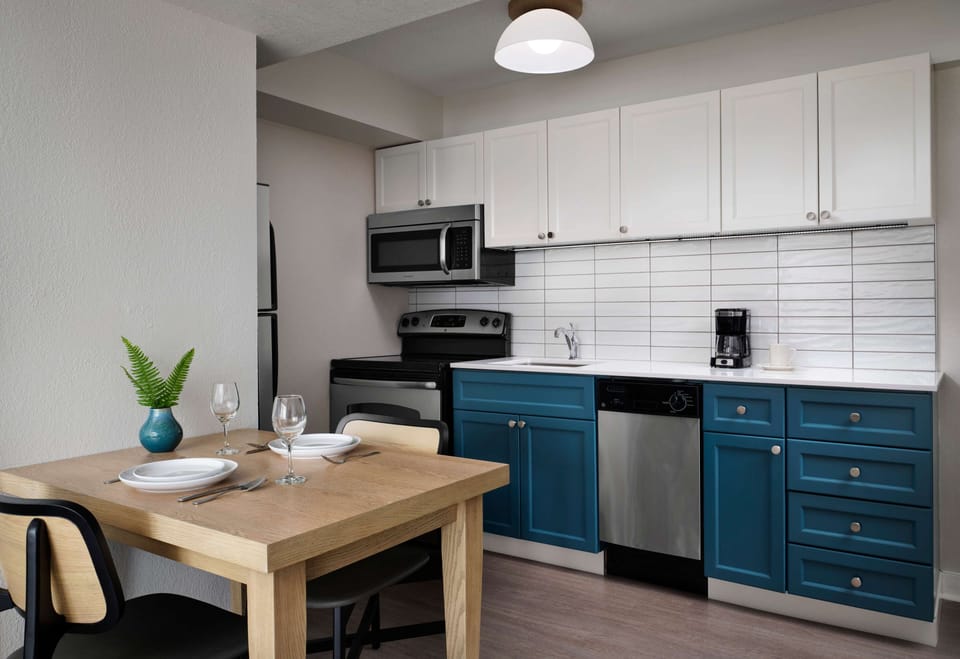 Cook easy meals in a sleek kitchenette with dining table.