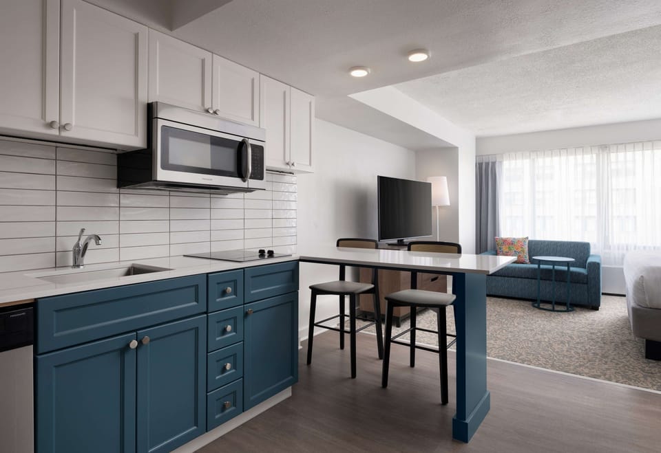 Gather for snacks and conversation in the open-plan kitchenette area.