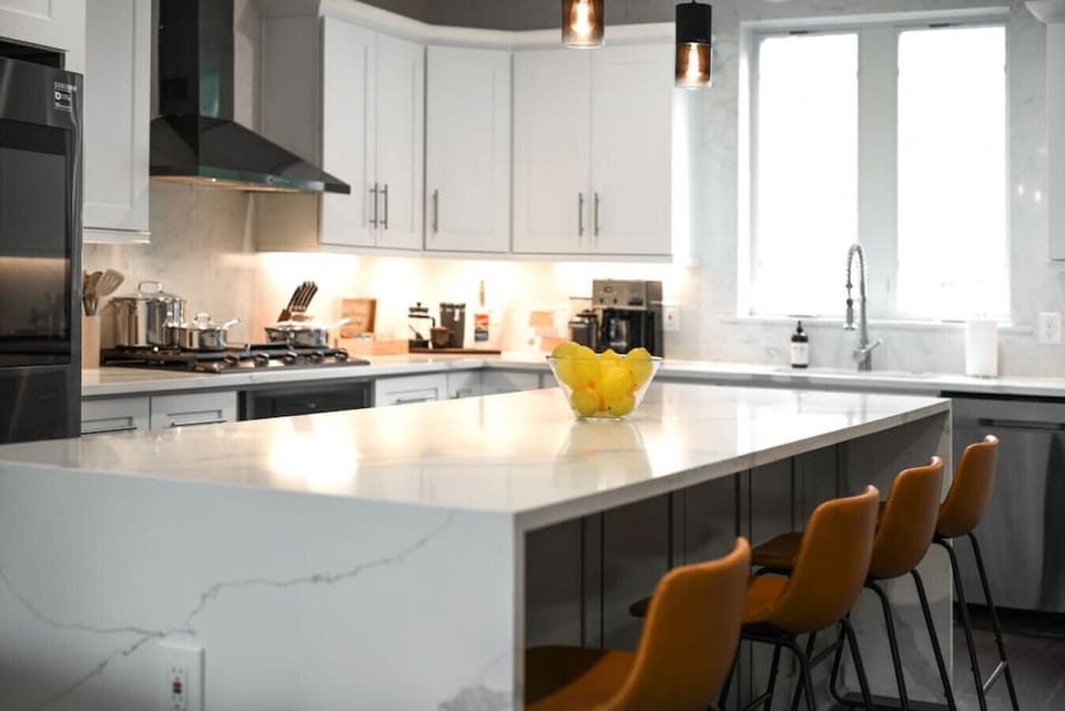 Chef’s kitchen with oversized island, quartz counters & bar seating