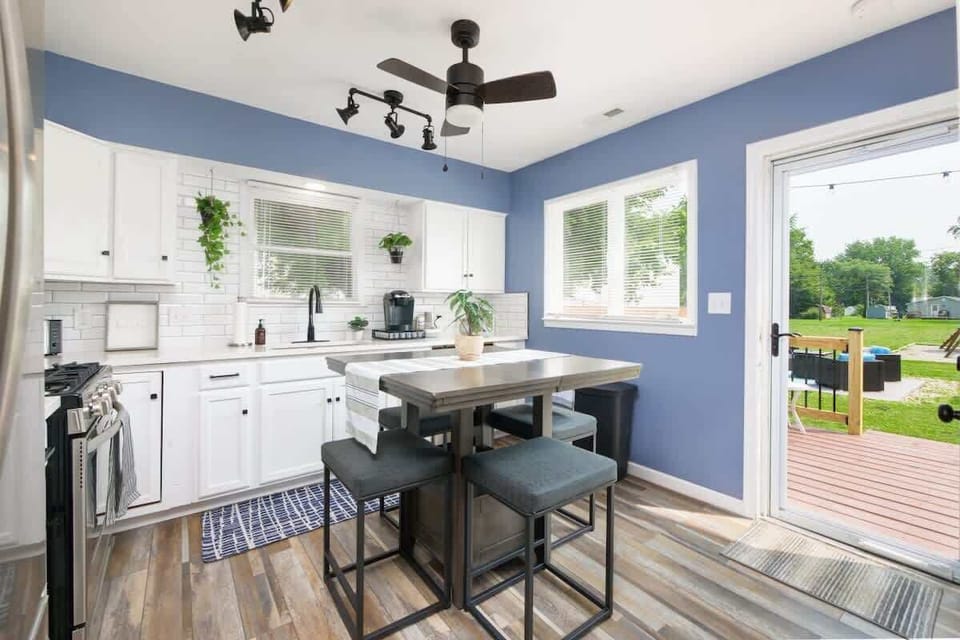Open kitchen w/ island seating & easy access to backyard, perfect for morning coffee or meals