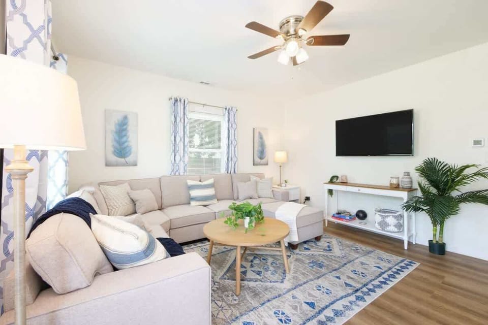 Bright, airy, and beautifully styled ☀️ This cozy living room features a comfy sectional, smart TV, and calming coastal touches—perfect for movie nights or morning coffee vibes ☕
