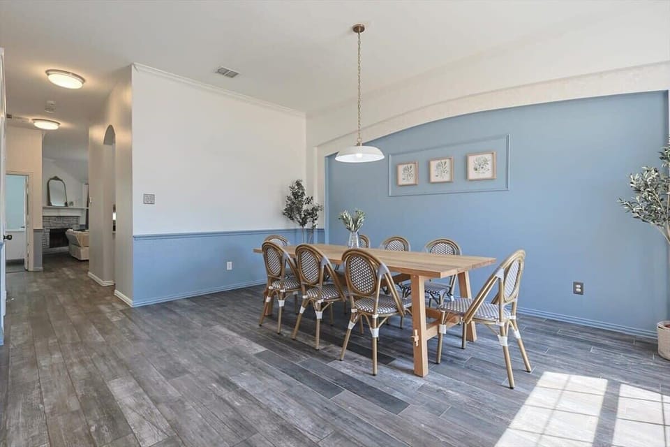 Gather around with some of your favorite people as you settle into this intimate dining room, featuring beautiful matching blue accents and plenty of natural sunlight.