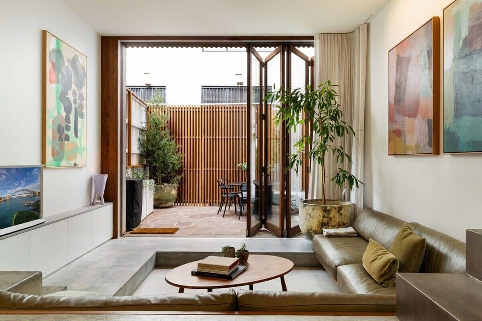 Large leather sunken lounge connects to the private courtyard via large floor to ceiling timber bi-folds.