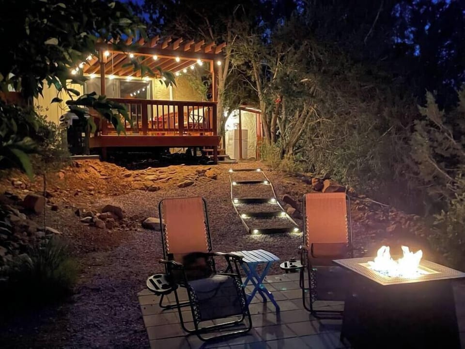 The back yard features a gas fire table, patio, deck with pergola and grill.