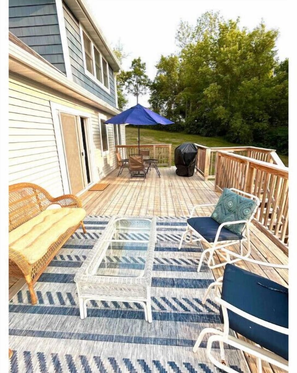 deck with sitting area, table with four chairs and grill