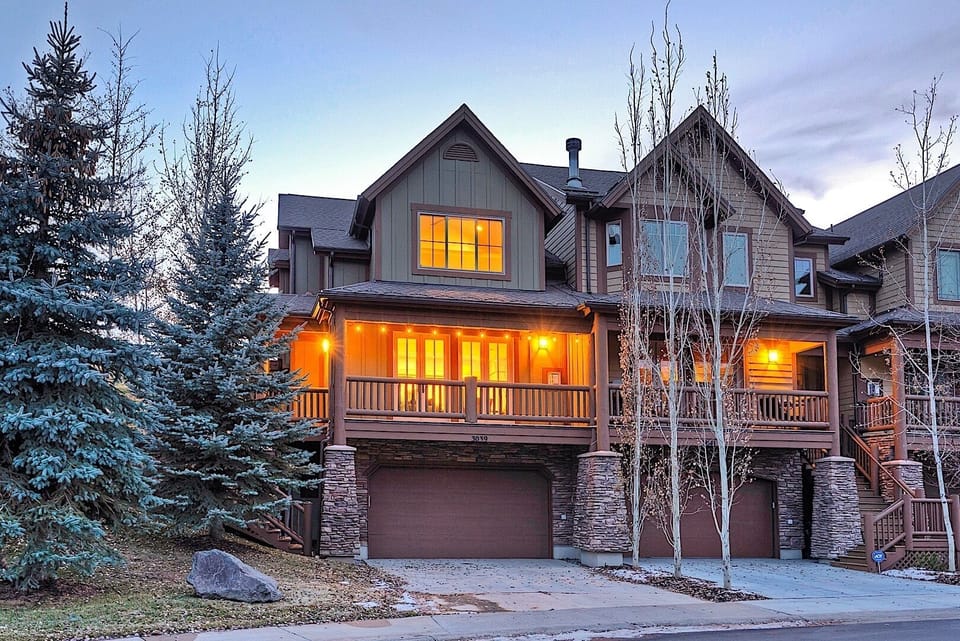 - Arrive at a warm and welcoming mountain townhouse  
- Spacious front porch lit with glowing evening lights  
- Perfect retreat close to outdoor adventure spots