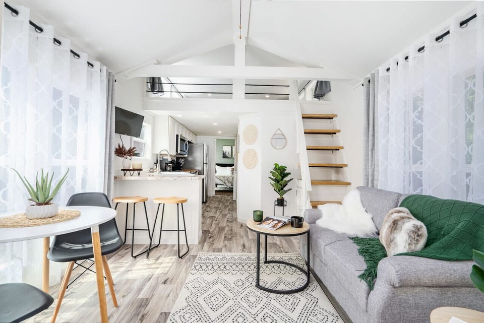 Bright, airy living space with calming tones and cozy seating designed for relaxing weekends away.