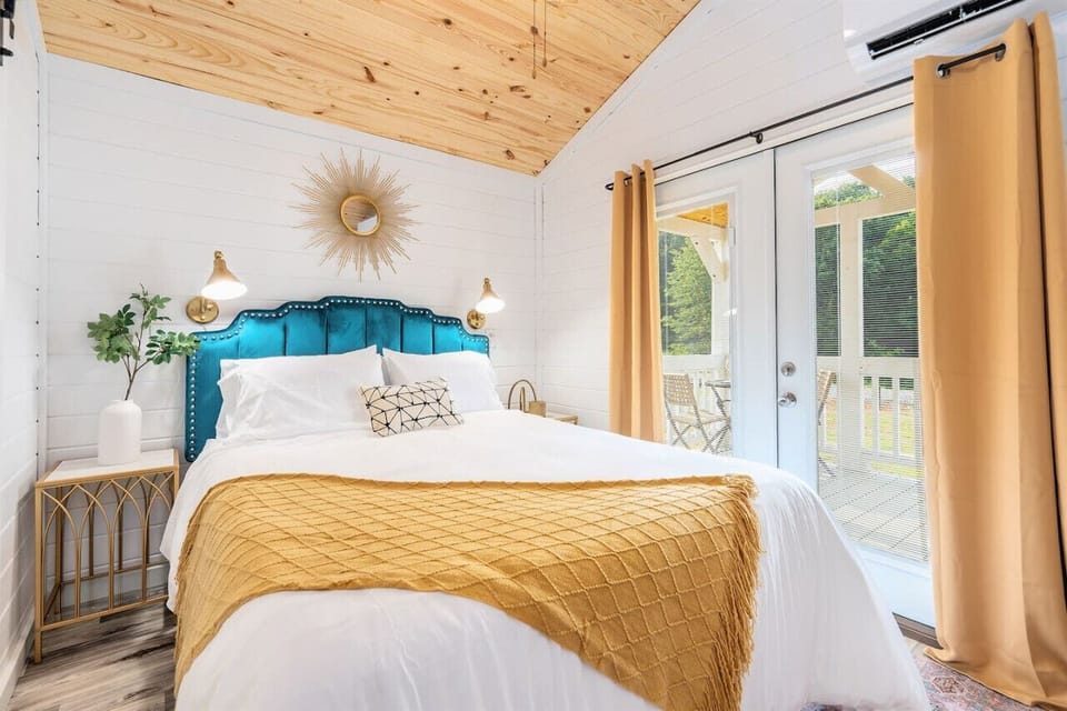 Wake up slow in the cozy queen bedroom with warm sunlight and soft linens.
