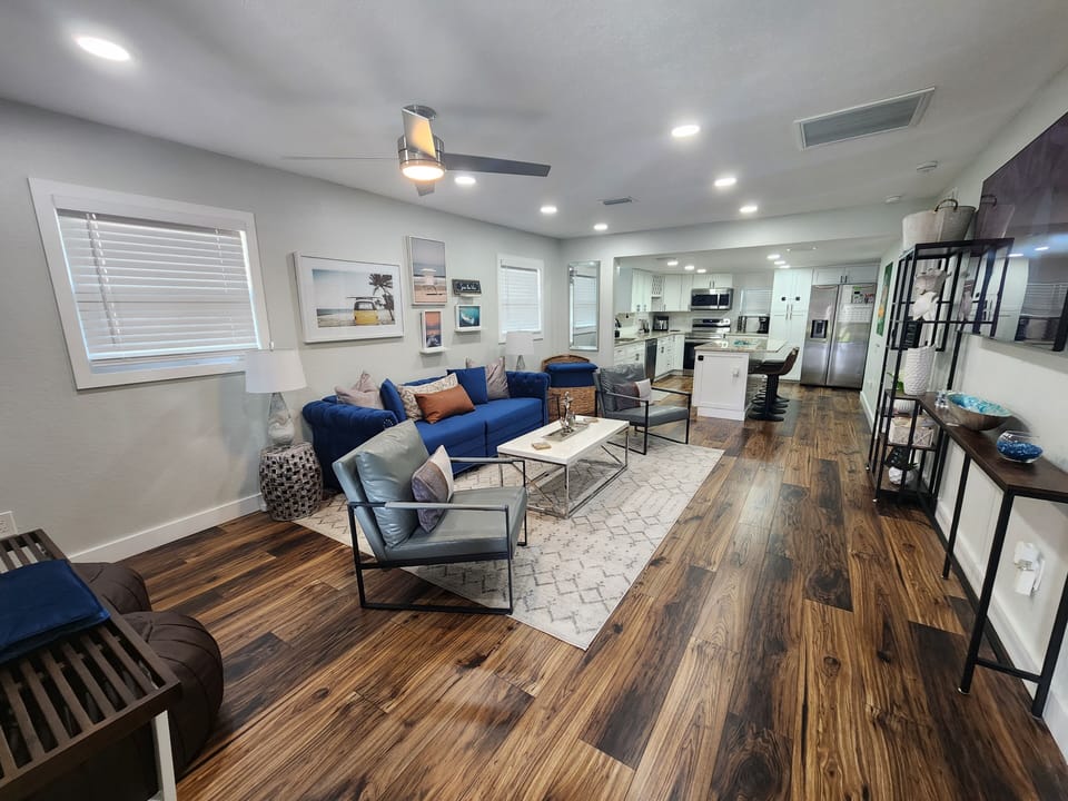 Bright living space to kitchen, 65” TV, ample seating, sofa becomes king bed.