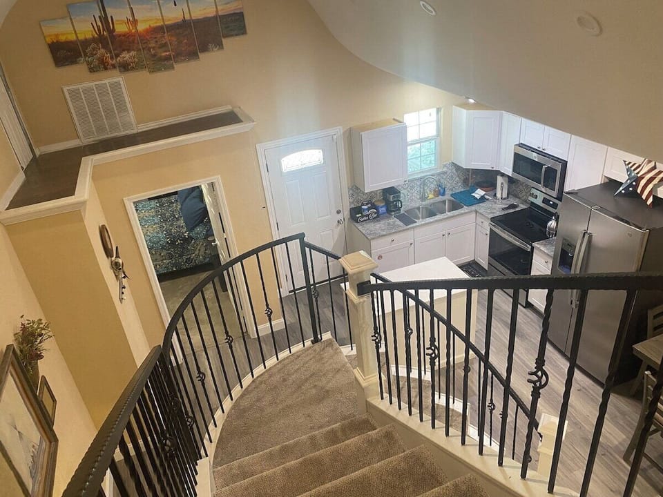 Kitchen view from atop curved staircase