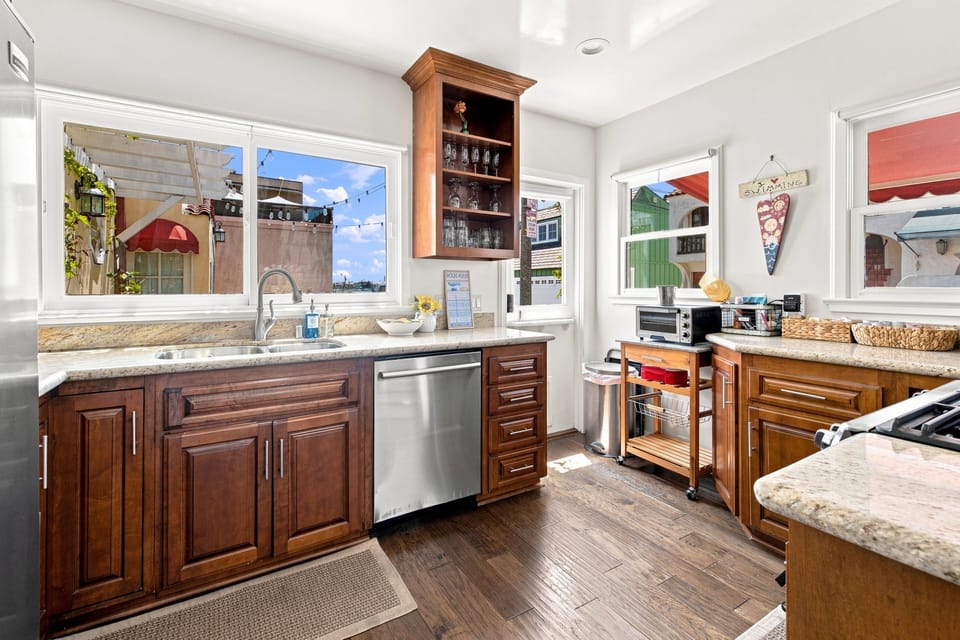Bright gourmet kitchen with stone counters and abundant natural light
