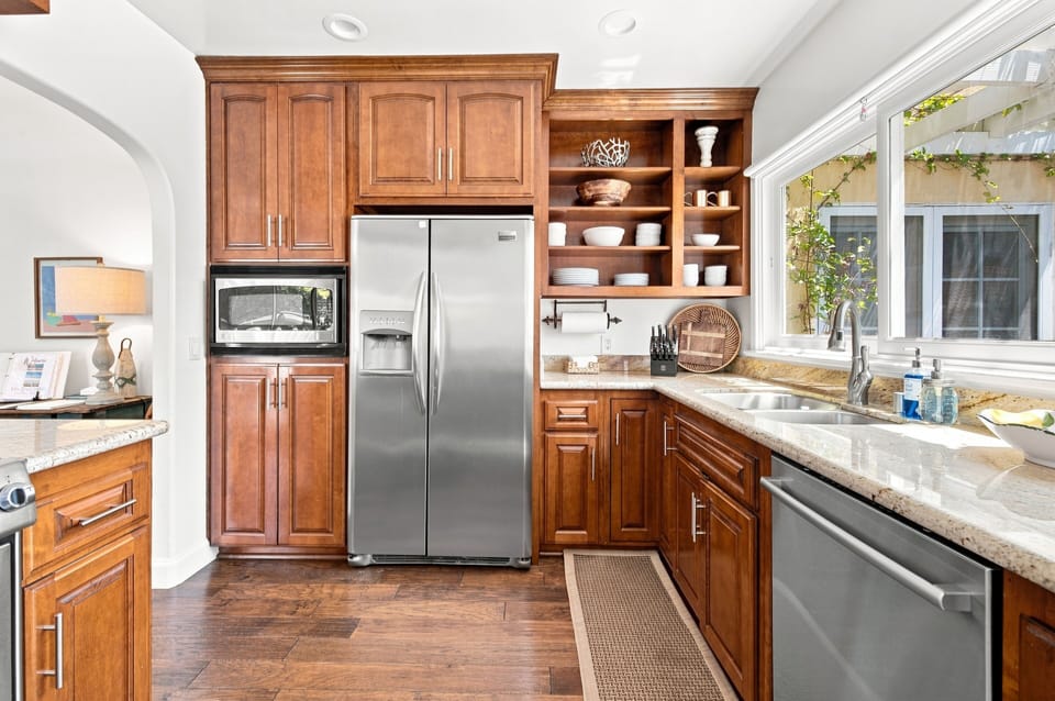 Bright gourmet kitchen with granite counters and stainless appliances