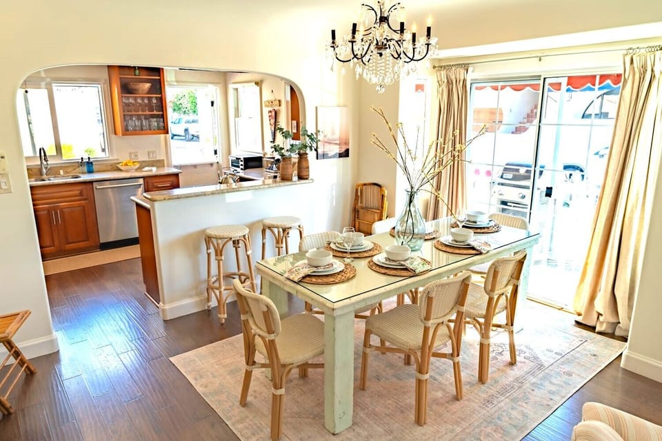 The dining area features a vintage farmhouse dining table, with seating for 8. 
