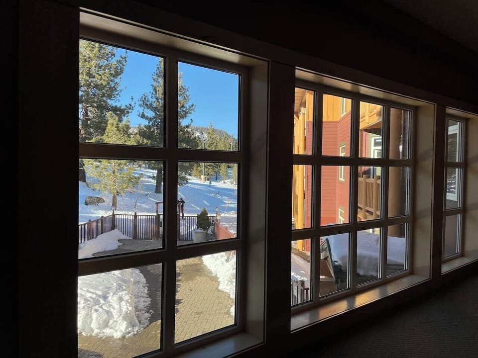 View of pool/BBQ patio and ski in/out trail entrance from second floor