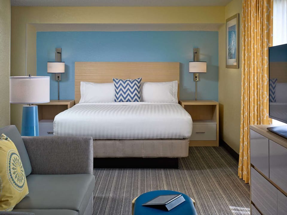 Unwind in a spacious suite with cozy seating and TV.