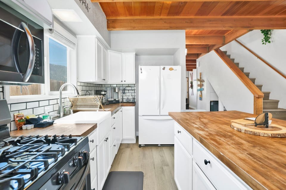 Fully equipped cabin kitchen with ample cabinetry, stove, fridge, and coffee maker—perfect for cooking meals, morning coffee, and feeling right at home on your stay.