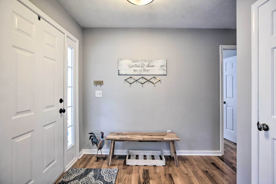 Entryway foyer with coat hooks and space for shoes, coats, and gear