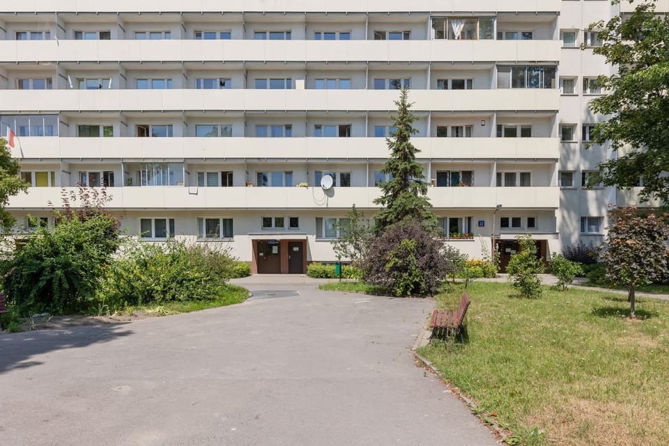 The exterior of the building with well-maintained green spaces and a welcoming walkway.

