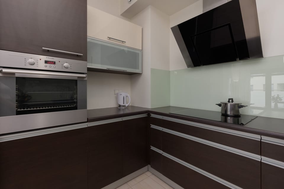 A close-up of the kitchen corner with a fruit bowl and stainless steel appliances.

