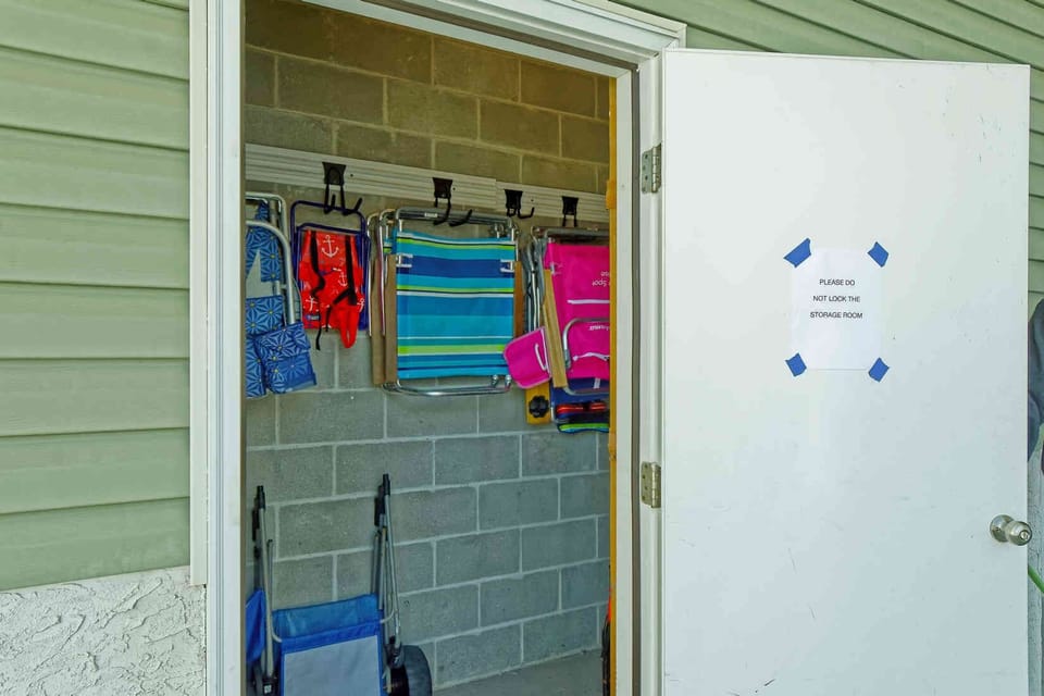 Storage on first floor with beach chairs, cart and beach toys for your enjoyment
