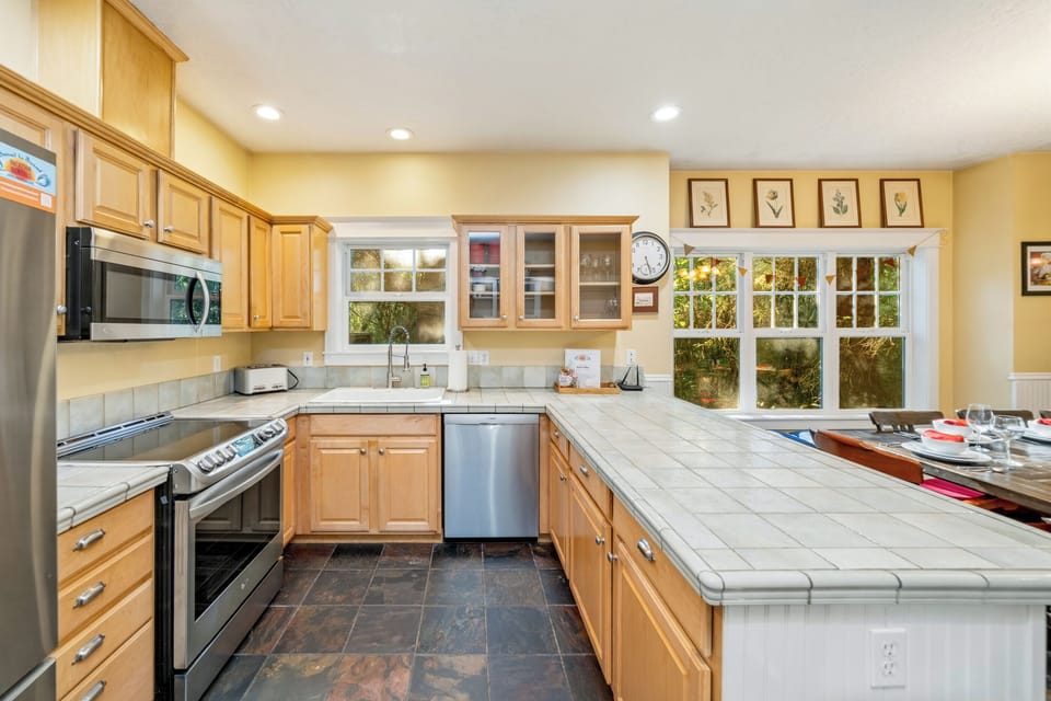 Fully equipped kitchen open to the dining room with window seat