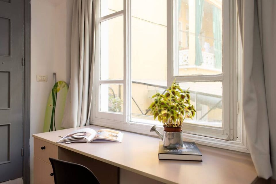 Cozy desk nook with natural light and a peaceful view.