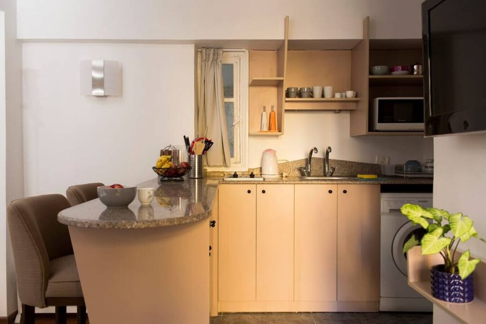 The kitchenette and adjoining bar is fully equipped, with all necessary utensils and appliances.